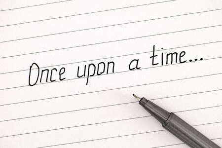 Handwriting text Once Upon a Time on lined paper with pen. Close-up.の写真素材
