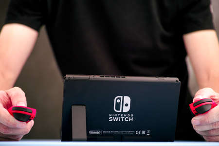 Tambov, Russian Federation - September 07, 2019 Man playing Nintendo Switch video game console...