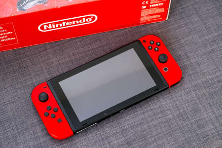 Tambov, Russian Federation - June 22, 2019 Nintendo Switch video game console and Nintendo red box. Gray background.のeditorial素材