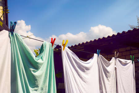 Washed laundry hanging on backyard. Summer time.の写真素材