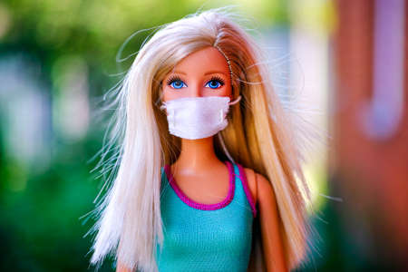 Tambov, Russian Federation - June 12, 2020 Portrait of brlonde Barbie doll with medical mask outdoors.のeditorial素材