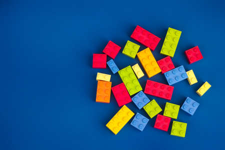 Tambov, Russian Federation - August 26, 2020 Heap of Lego blocks against blue background.のeditorial素材
