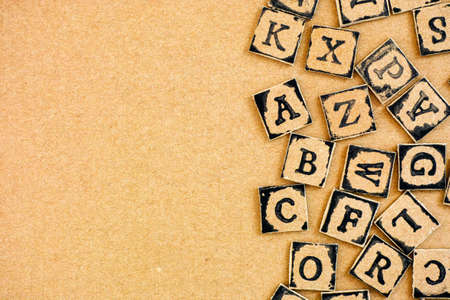 Cardboard letters made by alphabet stamps spelled out on cardboard backgrounds.