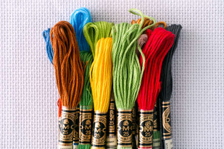 Tambov, Russian Federation - October 20, 2020 Pile of different colors DMC Six Strand Floss on white...