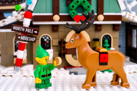 Tambov, Russian Federation - January 08, 2021 Lego Elf feeding waffle to Reindeer against Elf Club Houseのeditorial素材