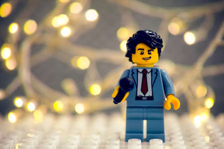 Tambov, Russian Federation - January 17, 2021 Lego reporter minifigure with microphone against a christmas light backgroundのeditorial素材