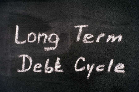 Chalk writing words Long Term Debt Cycle on blackboard. Close-upの写真素材
