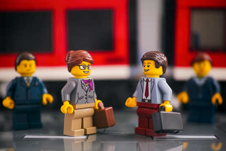 Tambov, Russian Federation - March 03, 2021 Lego Businesspeople standing on the platform in front of a red trainのeditorial素材