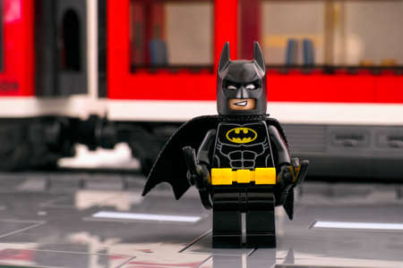 Tambov, Russian Federation - March 03, 2021 Lego Batman standing on the platform in front of a red trainのeditorial素材
