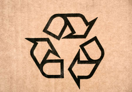 Recycling symbol on cardboard. Fragile or packaging symbol. Close-up