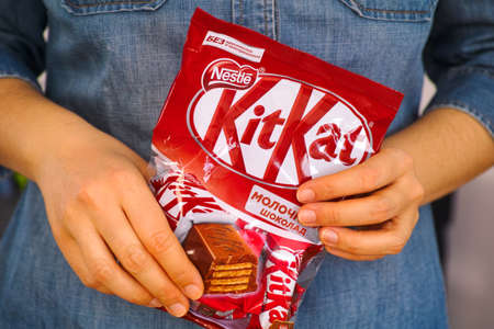 Tambov, Russian Federation - January 30, 2021 KitKat candies pack by Nestle in woman hands.
