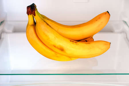 A bunch of bananas on shelf in fridge. Close up.の写真素材