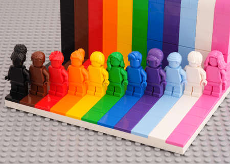 Tambov, Russian Federation - August 12, 2021 Eleven Lego monochrome minifigures against a rainbow backdrop. LEGO Everyone is Awesome kit.のeditorial素材