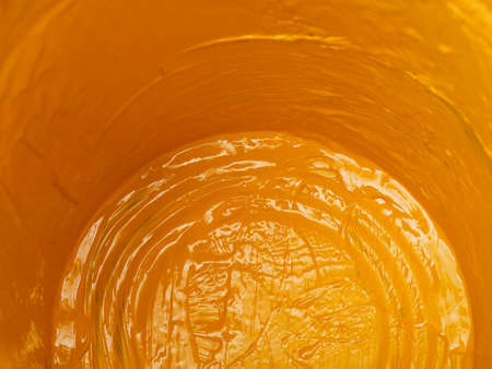 Close-up inside of an empty bucket of yellow paint.の写真素材