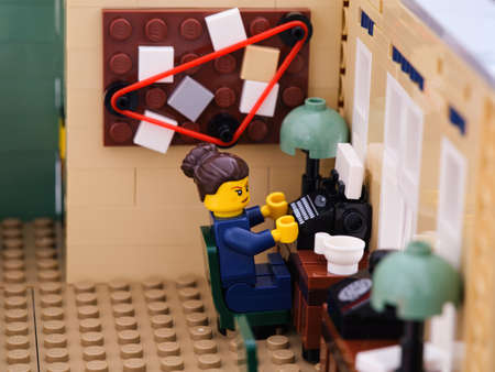 Tambov, Russian Federation - August 02, 2021 Lego policewoman is typing on a typewriter in police stationのeditorial素材