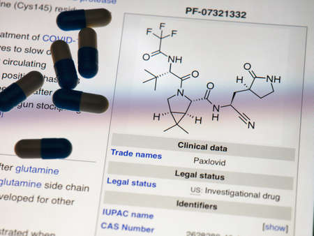 Tambov, Russian Federation - November 06, 2021 A screen that is showing a Wikipedia page with information about the PaxlovidÂ Â (molecular structure) by Pfizer Inc. with some pills on it. Paxlovid is the new antiviral Covid treatment.のeditorial素材