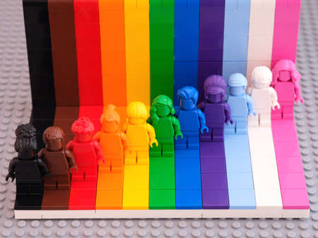 Tambov, Russian Federation - August 12, 2021 Eleven Lego monochrome minifigures against rainbow backdrop. LEGO Everyone is Awesome kit. Lego gray baseplate background.のeditorial素材