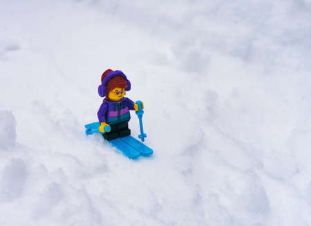 Tambov, Russian Federation - January 18, 2022 A Lego girl minifigure skiing down a snowy hillのeditorial素材