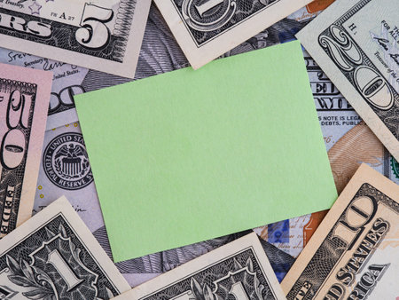 A Green paper note on a United States Dollar bills background.