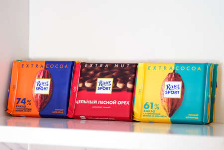Tambov, Russian Federation - February 19, 2022 Three kinds of Ritter Sport chocolate bars on shelf of kitchen cupboardのeditorial素材