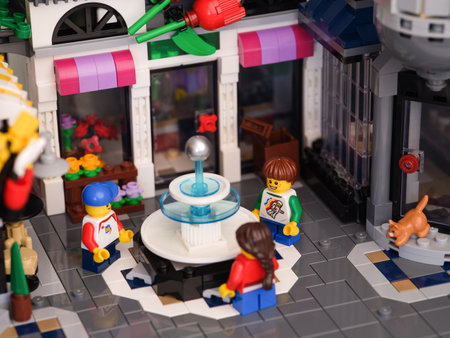 Tambov, Russian Federation - January 07, 2023 Three Lego child minifigures standing around a fountain in the city squareのeditorial素材