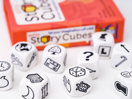 Tambov, Russian Federation - November 09, 2022 An orange box of Rory's Story Cubes and 9 cubes...