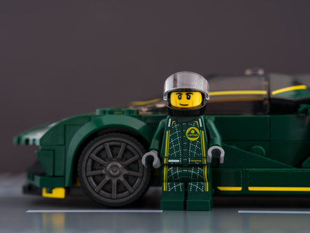 Tambov, Russian Federation - June 21, 2022 A Lego Lotus Evija driver minifigure near his car on a...