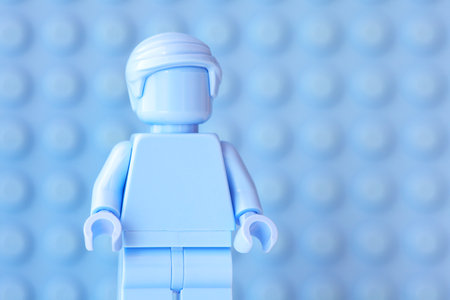 Tambov, Russian Federation - October 31, 2023 A Portrait of a Lego light blue minifigure against a light blue baseplate background.のeditorial素材