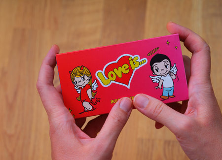 Tambov, Russian Federation - November 18, 2023 A Love Is chewing gum box in woman hands.