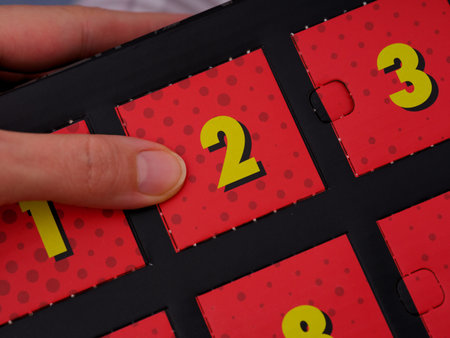 A woman finger opening a door with number 2 on an advent calendar.の写真素材