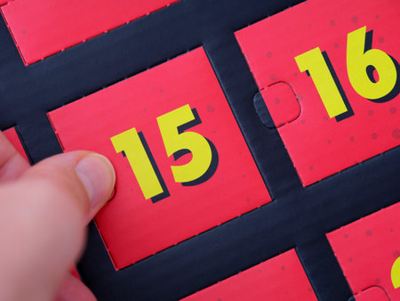 A woman hand opening a door with number 15 on an advent calendar.の写真素材