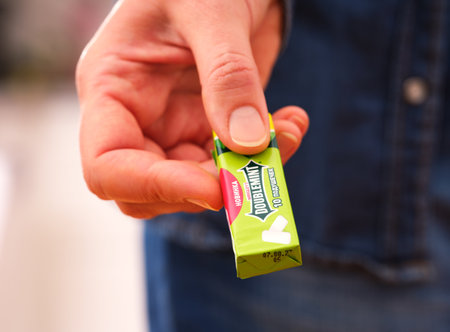 Tambov, Russian Federation - December 20, 2023 A woman giving a pack of Wrigley's Doublemint chewing gum.のeditorial素材