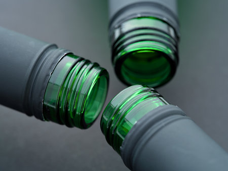 A close-up shot of three open neck of wine bottles on a black backgroundの写真素材