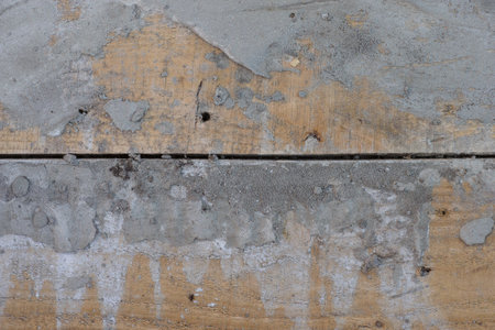 A wooden surface with dry cement on it
