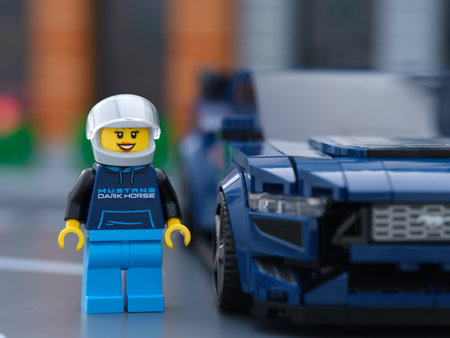 Tambov, Russian Federation - July 01, 2024 Lego Ford Mustang Dark Horse sports car driver minifigure standing near her car. LEGO Speed Champions.のeditorial素材