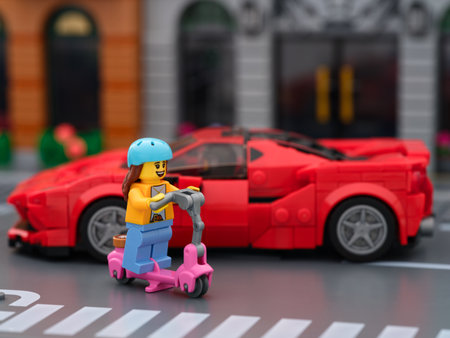 Tambov, Russian Federation - July 01, 2024 A Lego girl minifigure riding a scooter down the city...