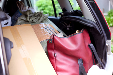The trunk of a car full of bags and boxesの写真素材
