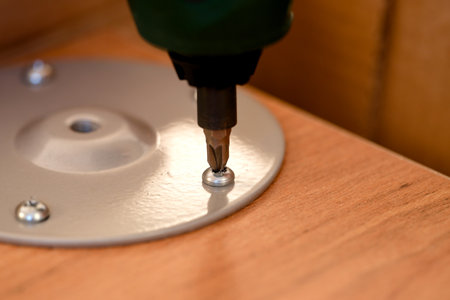 A screw drill twisting the screw on the furniture. Closeup.の写真素材