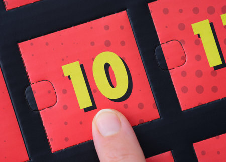 Woman finger pointing at the number 10 on an advent calendar.