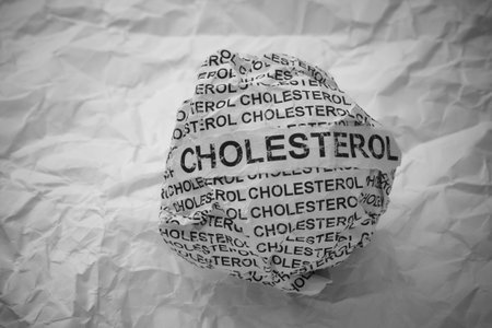 Crumpled paper ball with words Cholesterol on crumpled white paper background.の写真素材
