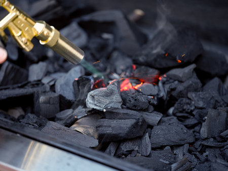 Blowtorch using to light charcoal in a BBQ grillの写真素材