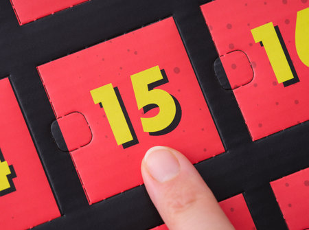 Woman finger pointing at the number 15 on an advent calendar.の写真素材