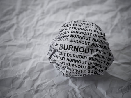 Crumpled paper ball with words Burnout on crumpled white paper background.の写真素材