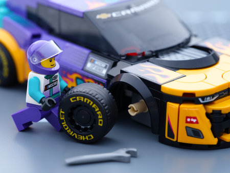 Tambov, Russian Federation - January 02, 2026 Lego driver minifigure changing wheel of his Lego...