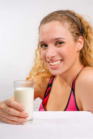 Young woman holding glass of milkの写真素材