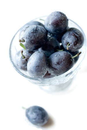 Plums in glass bowlの写真素材