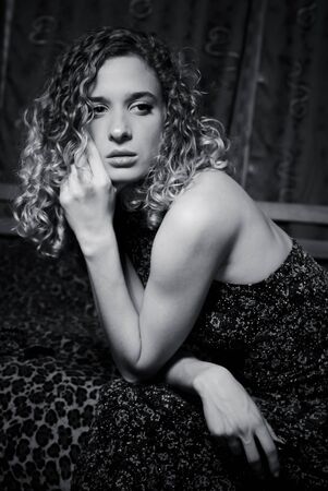 Woman in night dress sitting tired black-and-whiteの写真素材