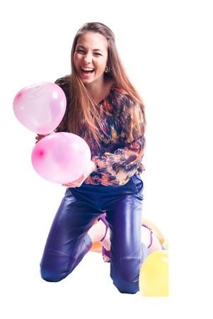 Beautiful young lady wearing leather trousers with balloons studio shot isolatedの写真素材