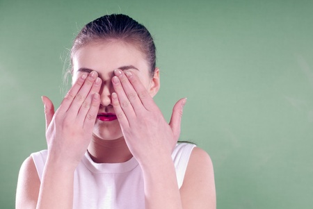 Young woman with eyes closed over greenscreen background