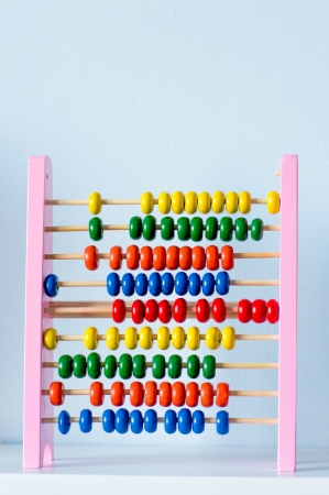 Education concept - Abacus with many colorful beads on book shelf at homeの写真素材